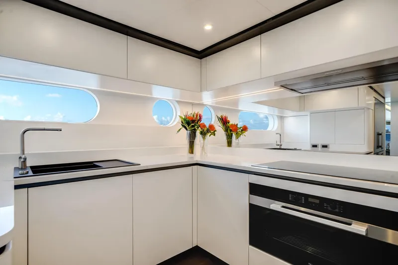 Slide: The Image of Luxurious kitchen interior of 2026 Azimut Magellano 30M yacht with modern design and floral decor. - 23