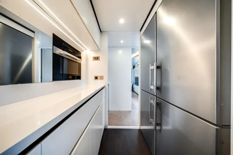 Slide: The Image of Modern kitchen interior on Azimut Magellano 30M yacht, featuring sleek appliances and minimalist design. - 26