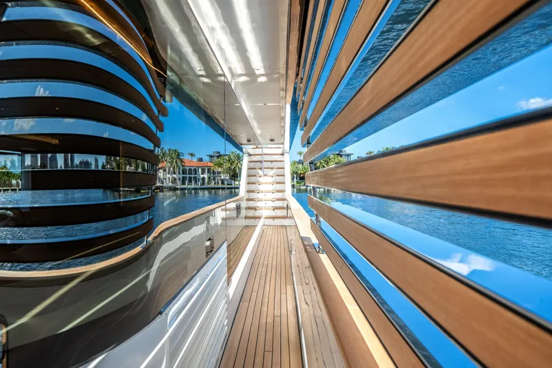 Slide: The Image of Luxurious Azimut Magellano 30M yacht deck with sleek wood paneling, reflecting serene waterfront views. - 41