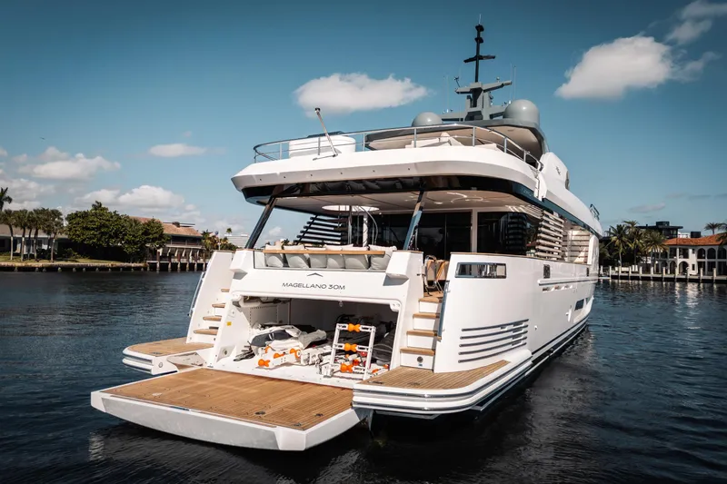 Slide: The Image of Luxury Azimut Magellano 30M yacht, 2026 model, docked in a serene waterfront setting. - 5