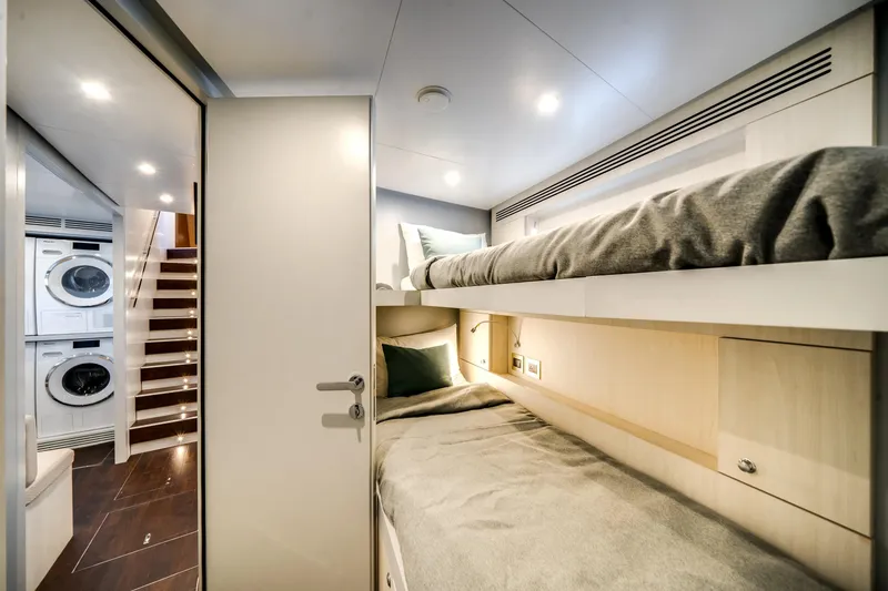 Slide: The Image of Luxurious Azimut Magellano 30M 2026 yacht interior with bunk beds and laundry area. - 61
