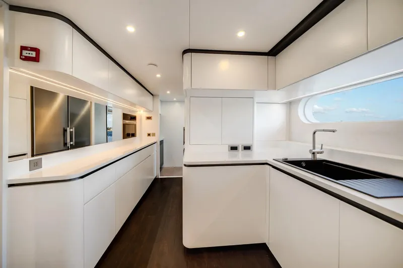 Slide: The Image of Modern kitchen interior on 2026 Azimut Magellano 30M yacht, featuring sleek white cabinetry. - 90