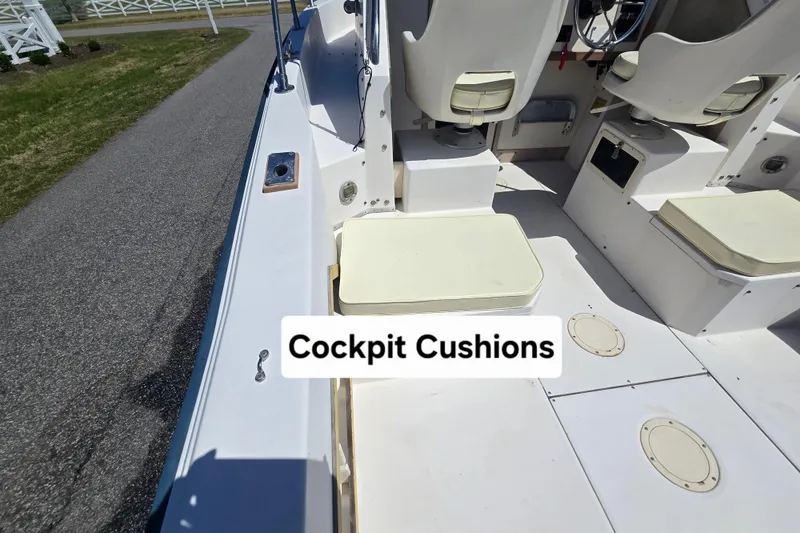 Slide: The Image of 1992 Grady White 226 boat cockpit with cushioned seating and steering area. - 10