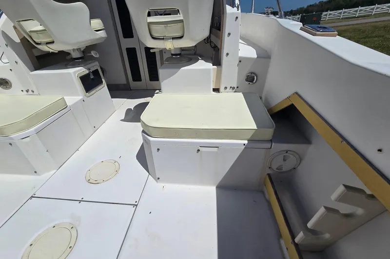 Slide: The Image of Interior of a 1992 Grady White 226 boat, featuring white seating and storage compartments. - 15