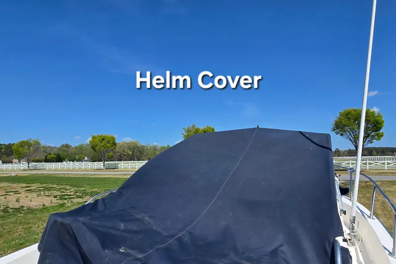 Slide: The Image of Covered helm of a 1992 Grady White 226 boat under clear blue sky. - 18