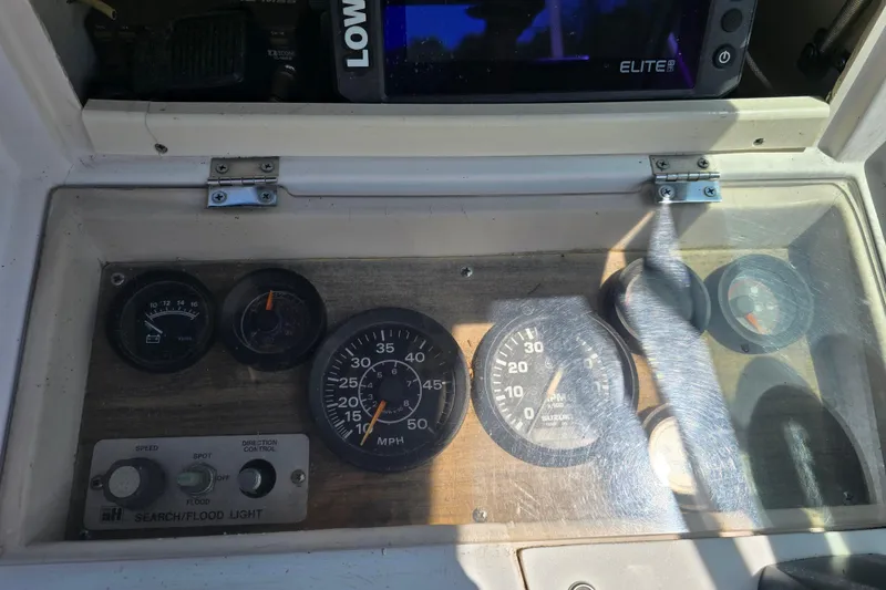 Slide: The Image of Dashboard of a 1992 Grady White 226 boat with gauges and controls. - 21
