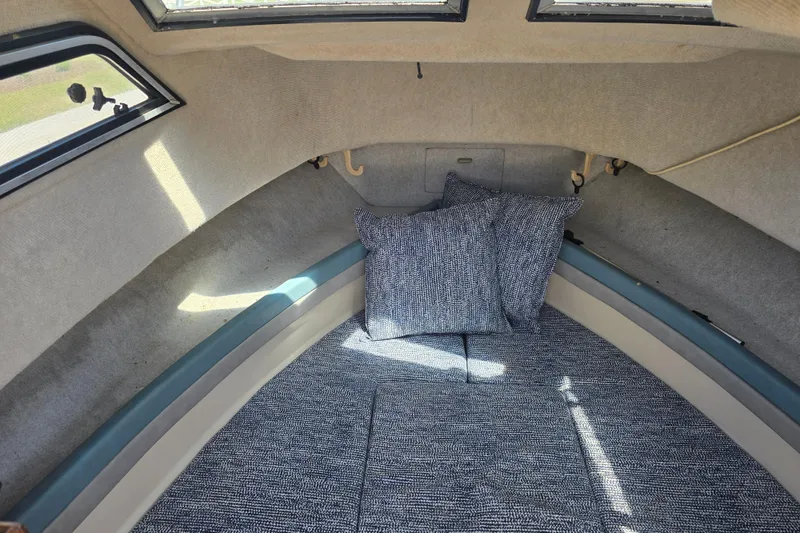 Slide: The Image of Interior cabin of a 1992 Grady White 226 boat with cushions and windows. - 23