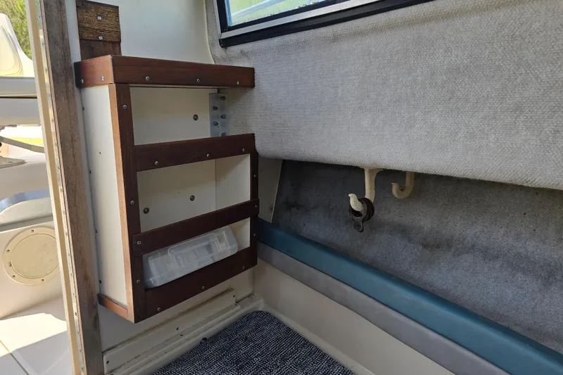 Slide: The Image of Interior of a 1992 Grady White 226 boat with wooden storage shelves. - 25