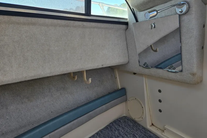 Slide: The Image of Interior of a 1992 Grady White 226 boat, featuring hooks and a mirror. - 26