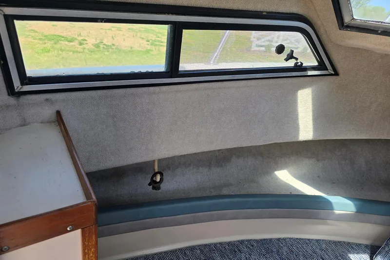 Slide: The Image of Interior cabin of a 1992 Grady White 226 boat, featuring windows and seating. - 28