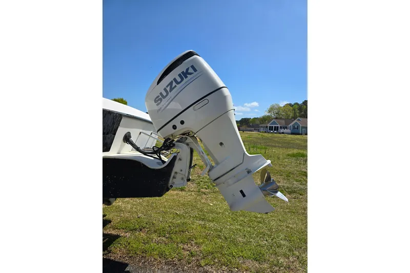 Slide: The Image of 1992 Grady White 226 boat with Suzuki outboard motor in grassy area. - 3