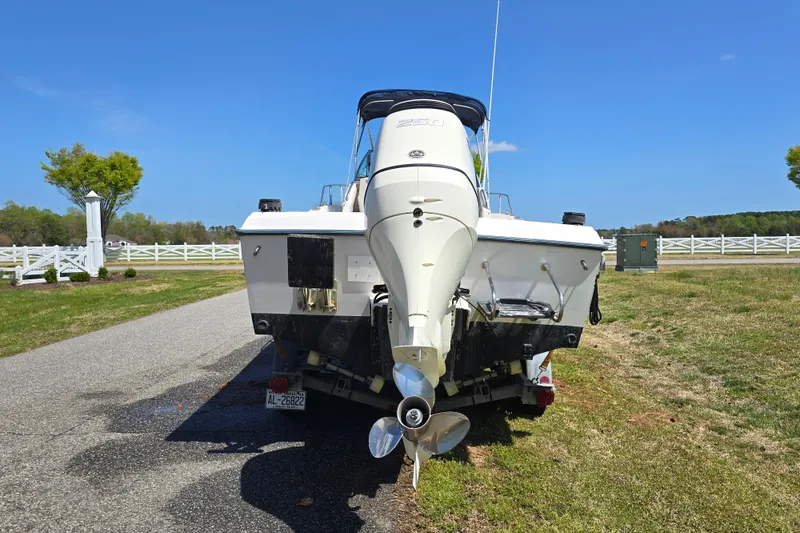 Slide: The Image of 1992 Grady White 226 boat on trailer, parked on roadside with clear blue sky. - 8