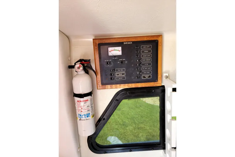 Slide: The Image of Control panel and fire extinguisher on a 2001 Skipjack 262 Flybridge boat. - 13
