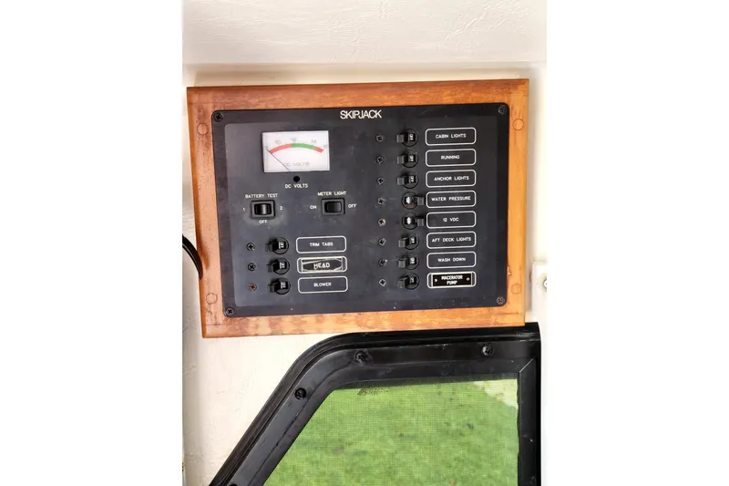 Slide: The Image of Control panel of a 2001 Skipjack 262 Flybridge boat with various switches and a voltmeter. - 14