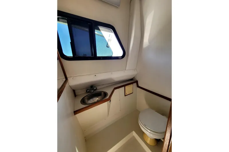 Slide: The Image of Interior of 2001 Skipjack 262 Flybridge boat bathroom with sink and toilet. - 18