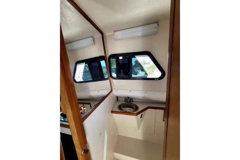 Slide: The Image of Interior of 2001 Skipjack 262 Flybridge boat with sink and windows. - 20
