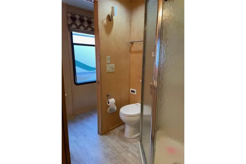 Slide: The Image of Bathroom interior of 2007 American Waterways Sundancer Trip, featuring shower and toilet. - 10