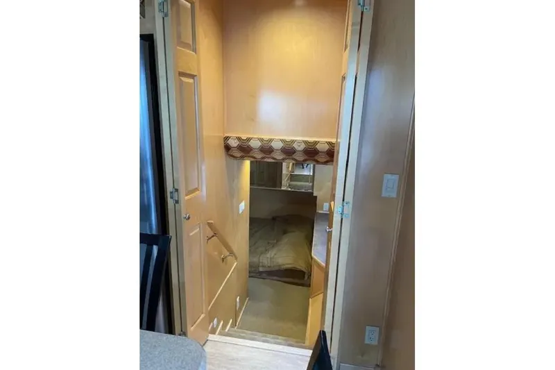 Slide: The Image of Interior view of a 2007 American Waterways Sundancer, featuring a cozy cabin space. - 12