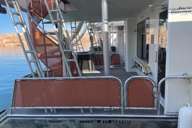 Slide: The Image of Houseboat deck with spiral staircase, American Waterways Sundancer Trip #15, 2007, on calm water. - 13