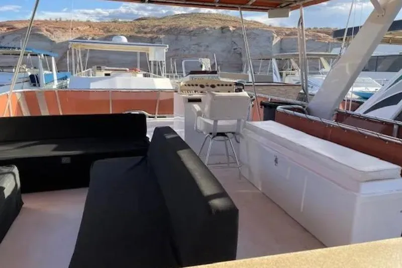 Slide: The Image of Upper deck of 2007 American Waterways Sundancer, featuring seating and helm, docked at marina. - 15