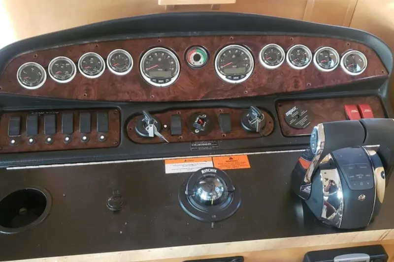 Slide: The Image of Control panel of 2007 American Waterways Sundancer boat with gauges and throttle. - 4