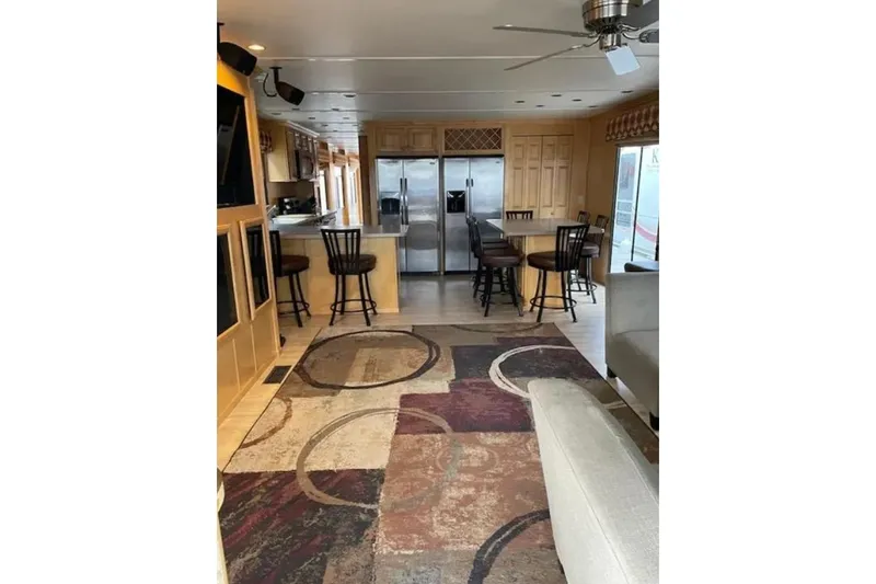 Slide: The Image of Luxurious houseboat interior with modern kitchen, bar stools, and patterned rug, 2007 American Waterways. - 5