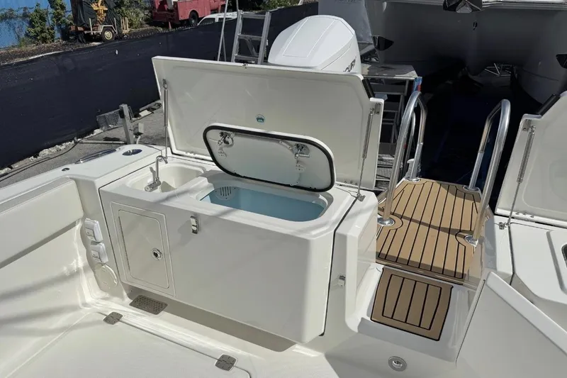 Slide: The Image of 2026 World Cat 400 CC-X boat deck with sink, storage, and ladder. - 10