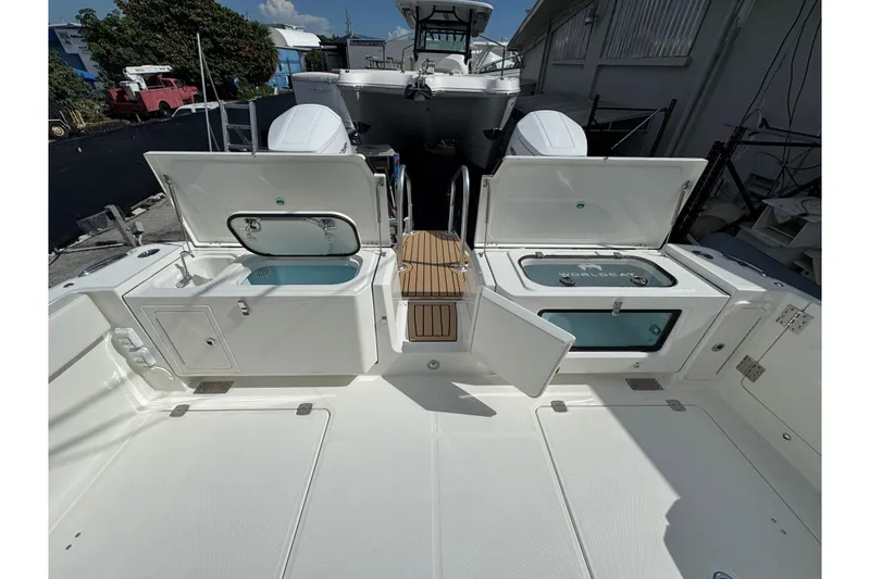Slide: The Image of 2026 World Cat 400 CC-X boat deck with open storage compartments and seating. - 11