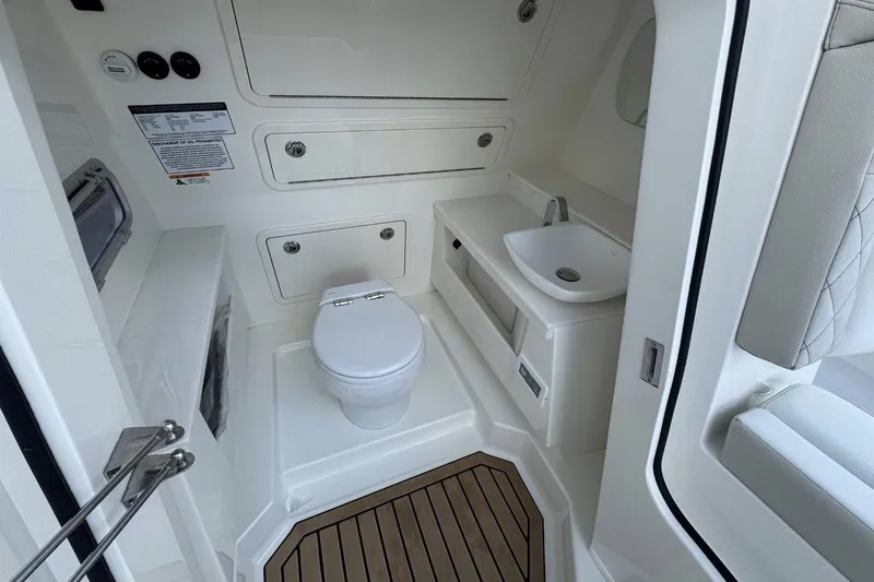 Slide: The Image of Luxurious 2026 World Cat 400 CC-X boat bathroom with modern fixtures and wood flooring. - 14