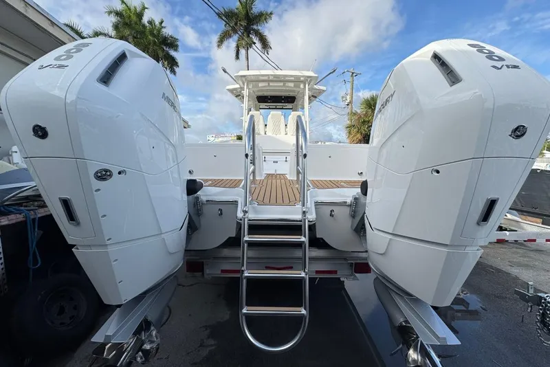 Slide: The Image of 2026 World Cat 400 CC-X boat with dual Mercury V12 engines, docked under a clear sky. - 18