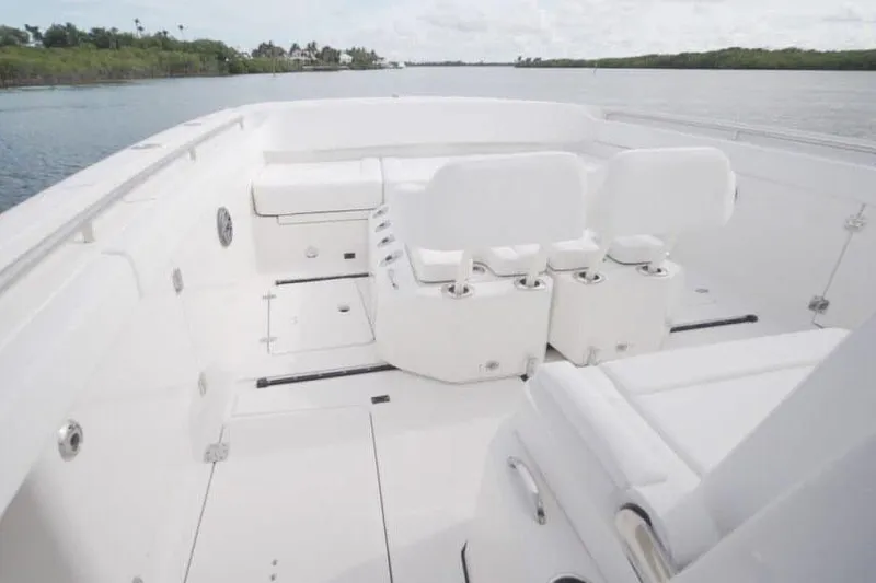 Slide: The Image of Manufacturer Provided Image: 2026 World Cat 400 CC-X boat interior with white seating, on a calm waterway. - 19