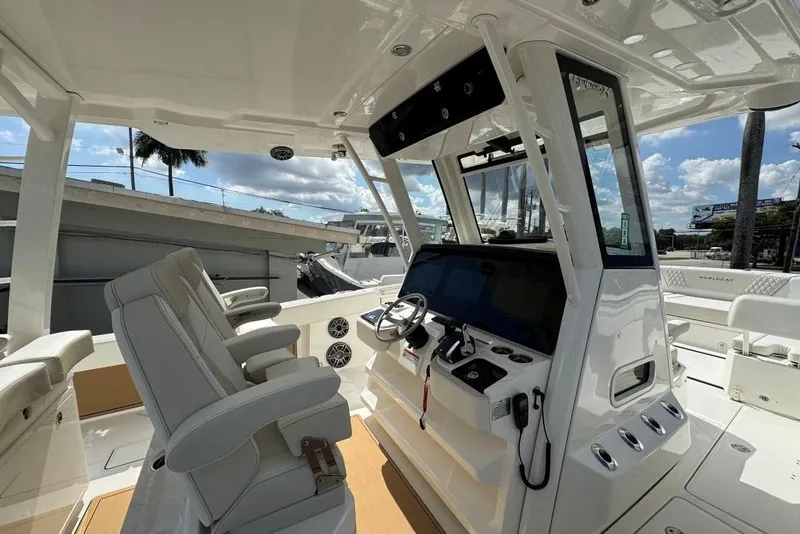 Slide: The Image of Interior view of 2026 World Cat 400 CC-X boat, featuring modern helm and seating. - 3