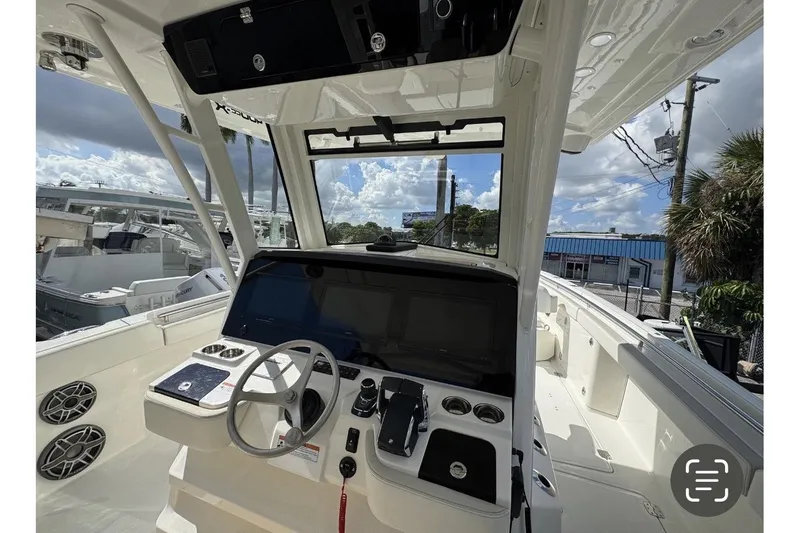 Slide: The Image of Interior view of 2026 World Cat 400 CC-X boat cockpit with steering wheel and controls. - 4