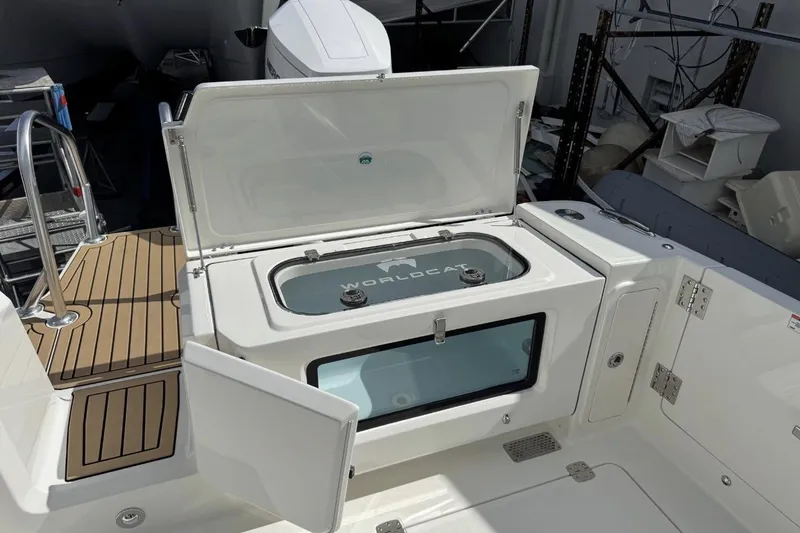 Slide: The Image of 2026 World Cat 400 CC-X boat with open storage compartment and teak deck. - 9