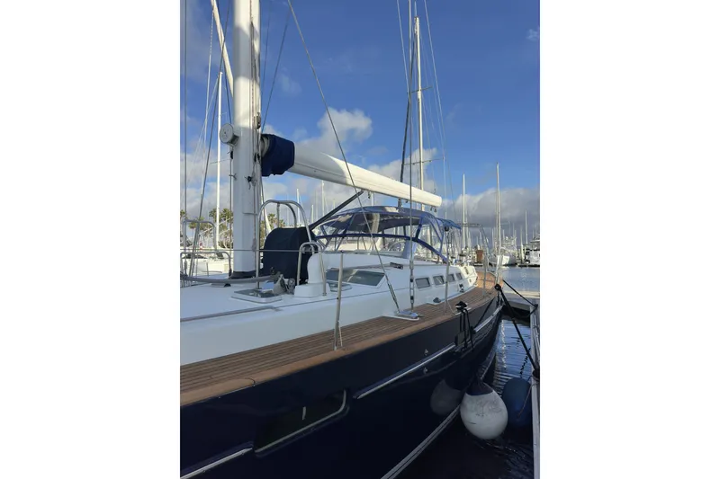 Slide: The Image of Sailing yacht Beneteau 57, 2003 model, docked at marina under clear blue sky. - 100