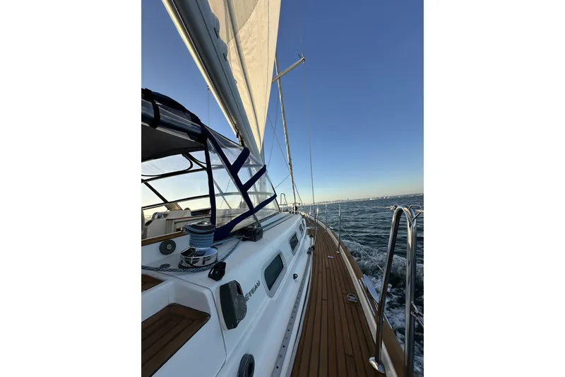 Slide: The Image of Sailing on a 2003 Beneteau 57 yacht with wooden deck and clear skies. - 107