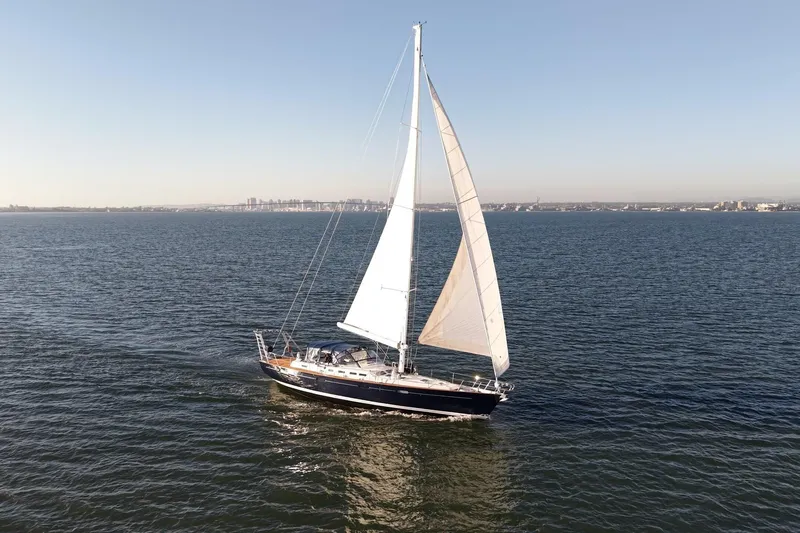 Slide: The Image of Sailing yacht Beneteau 57 (2003) cruising on open water under clear skies. - 112