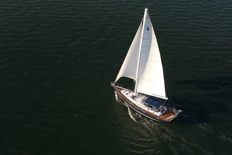 Slide: The Image of Aerial view of a 2003 Beneteau 57 sailboat navigating through open water. - 113