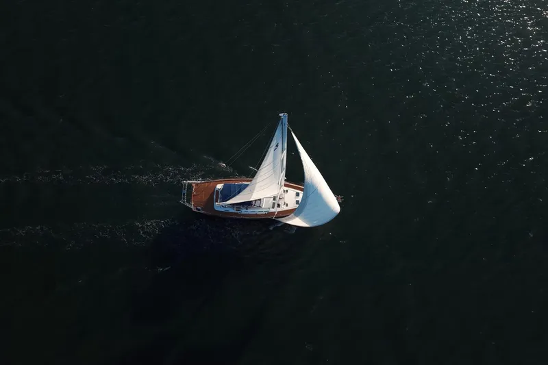 Slide: The Image of Aerial view of a 2003 Beneteau 57 sailboat navigating open waters. - 116