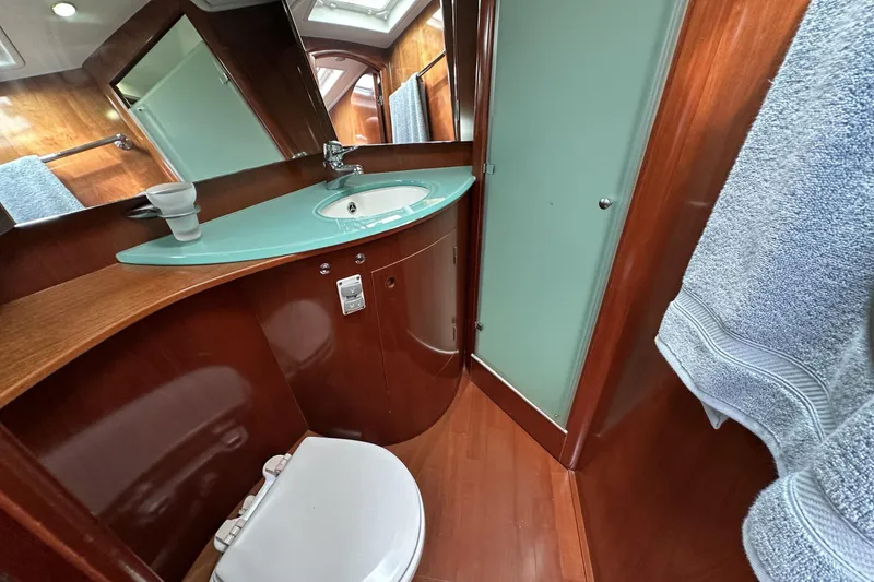 Slide: The Image of Luxurious bathroom in 2003 Beneteau 57 yacht with modern fixtures and wooden accents. - 12
