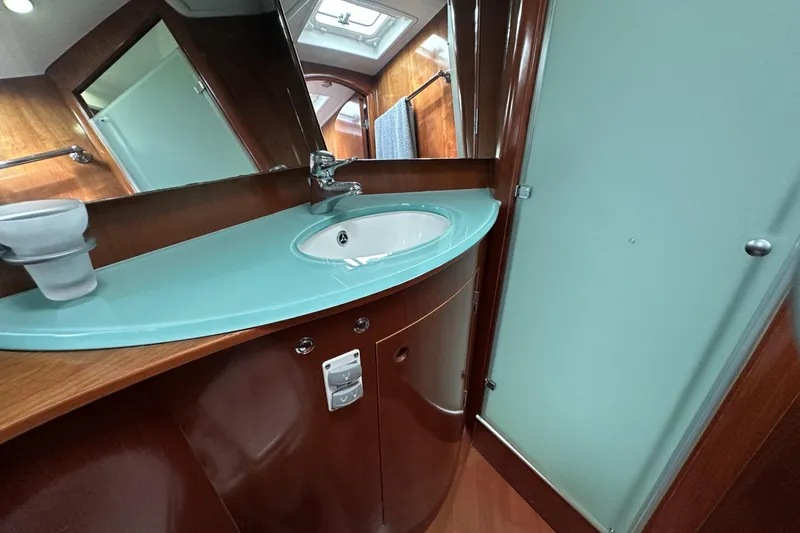 Slide: The Image of Luxurious bathroom interior of 2003 Beneteau 57 yacht with modern sink and mirror. - 13