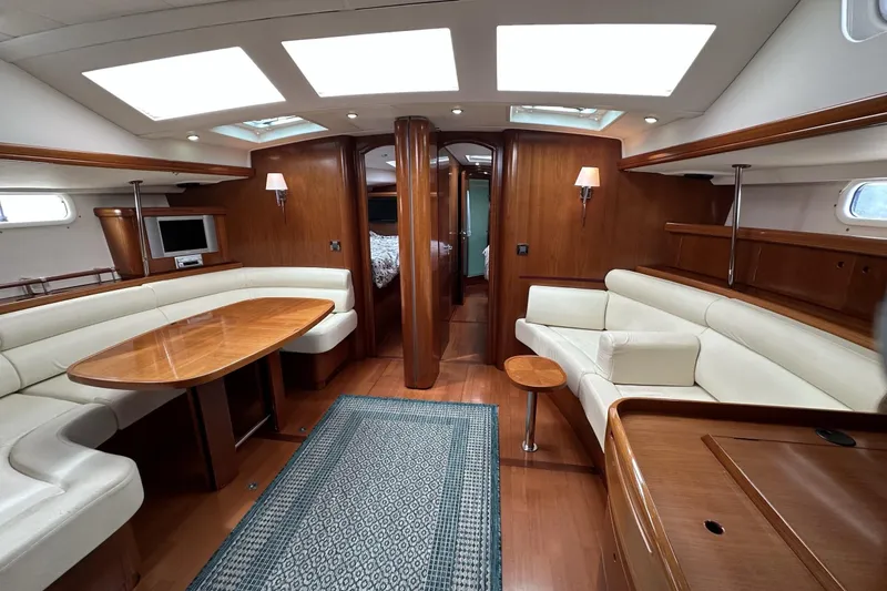 Slide: The Image of Luxurious interior of a 2003 Beneteau 57 yacht with elegant wood finishes and plush seating. - 16
