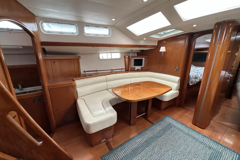 Slide: The Image of Luxurious interior of a 2003 Beneteau 57 yacht with elegant wood finishes and cozy seating. - 17