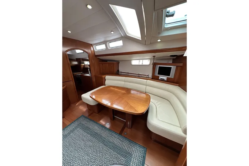 Slide: The Image of Luxurious interior of 2003 Beneteau 57 yacht with elegant wood finish and cozy seating. - 18