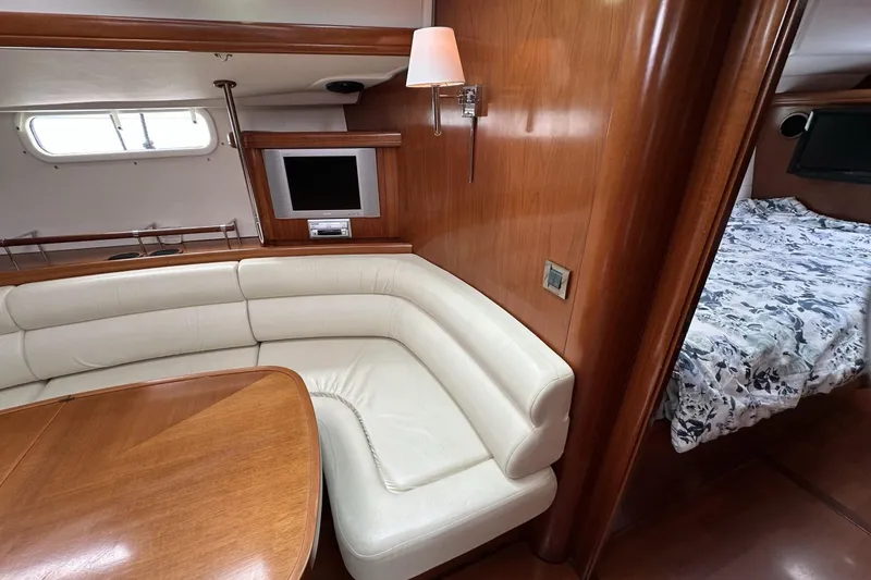 Slide: The Image of Luxurious interior of 2003 Beneteau 57 yacht with cozy seating and elegant wood finish. - 20