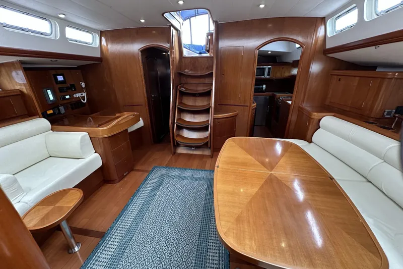 Slide: The Image of Luxurious interior of a 2003 Beneteau 57 yacht with elegant wood finishes and comfortable seating. - 21