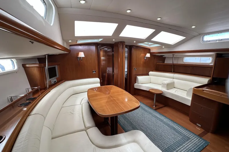 Slide: The Image of Luxurious interior of a 2003 Beneteau 57 yacht with elegant wood finishes and plush seating. - 22