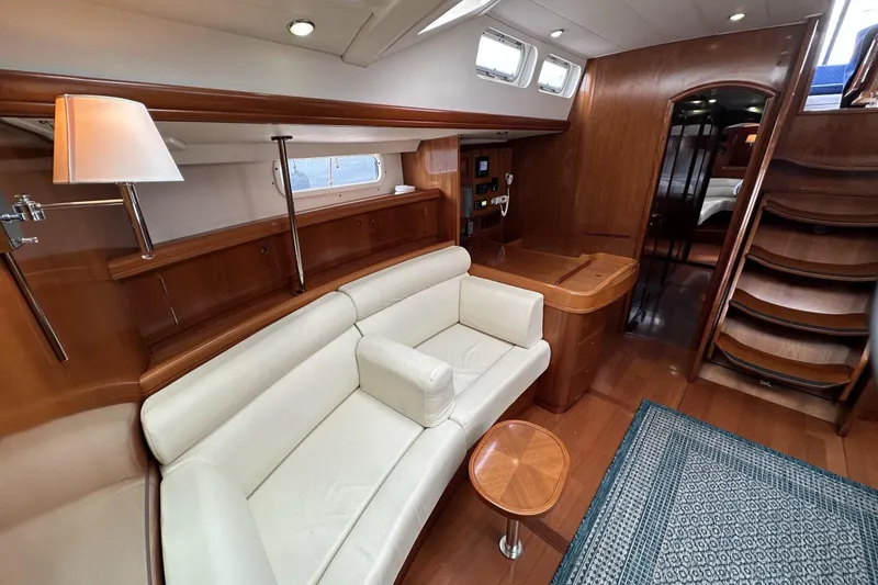 Slide: The Image of Luxurious interior of a 2003 Beneteau 57 yacht with elegant wood finishes and comfortable seating. - 23