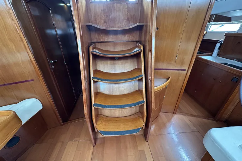 Slide: The Image of Interior of 2003 Beneteau 57 yacht with wooden stairs and cabinetry. - 24