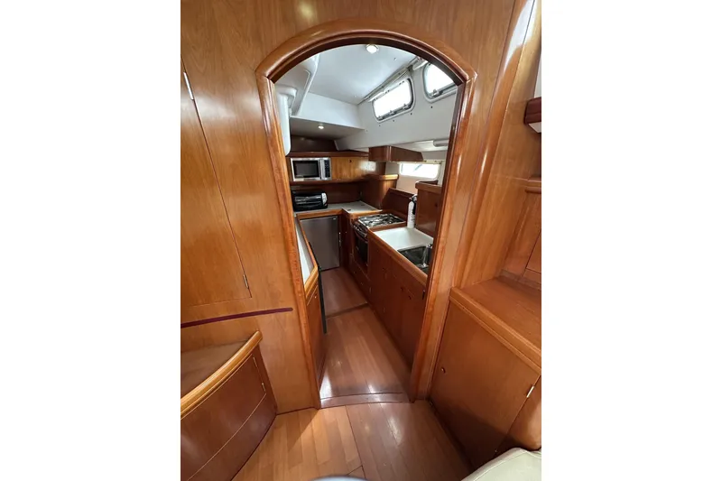Slide: The Image of Luxurious 2003 Beneteau 57 yacht interior with wood finish and modern kitchen amenities. - 25